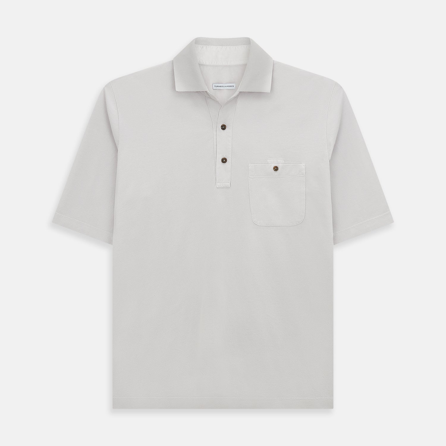 View 1 of product The Turnbull & Asser Pale Pink Polo Shirt is a cotton jersey short-sleeve polo with a collar, three brown buttons on the placket, and a button-flap chest pocket, shown against a white background.