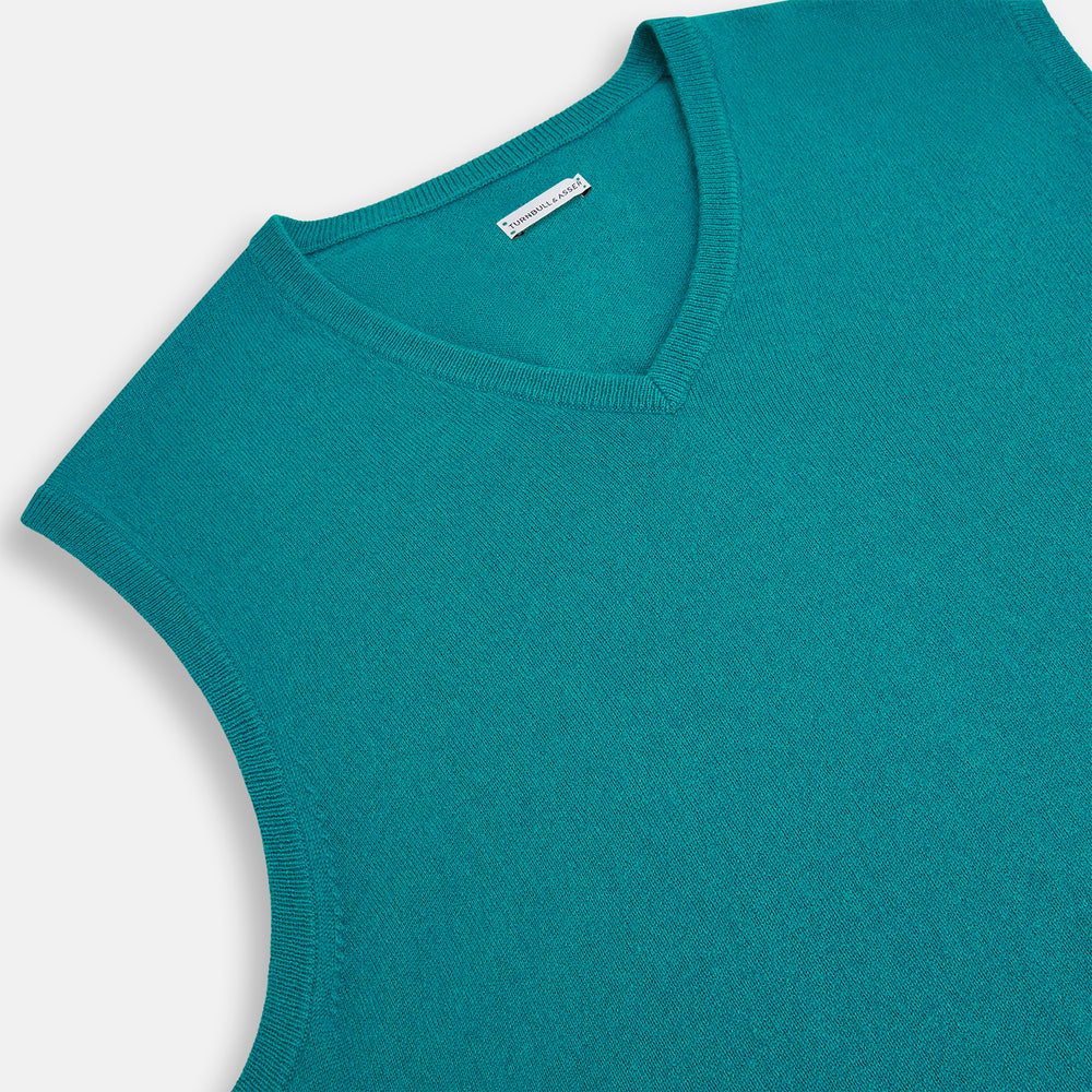 The Turnbull & Asser Turquoise Cashmere V-Neck Vest features ribbed detailing at the neck, armholes, and hem. Shown on a white background, its soft cashmere fabric brings refined charm to any distinguished look.