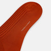 View 3 of product A single Rust Mid-Length Sock by Turnbull & Asser, knee-high and ribbed, made from mercerised Egyptian cotton, is shown in a side profile against a plain white background.