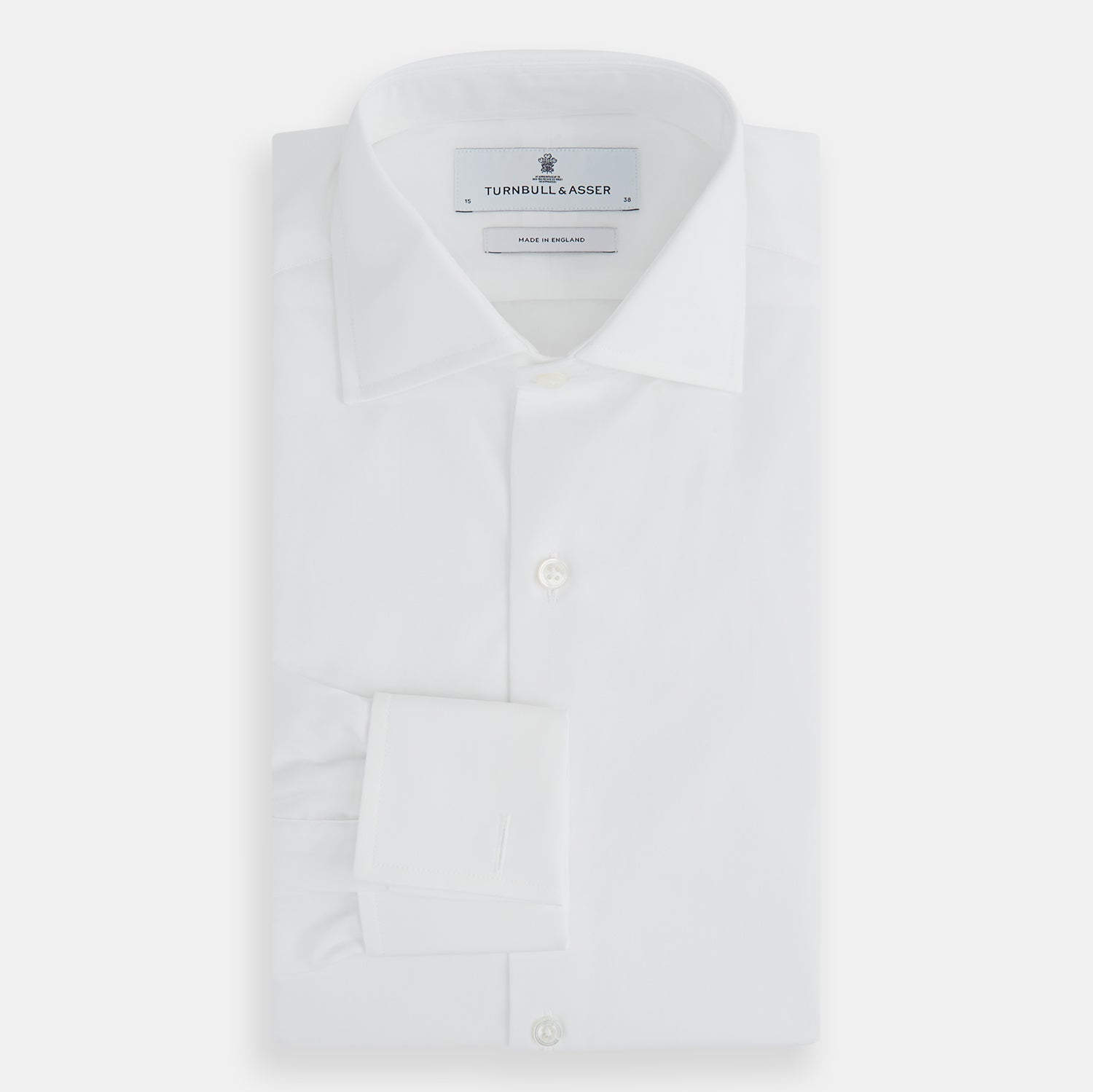 View 4 of product The Turnbull & Asser Tailored Fit Plain White Cotton Shirt features a Kent collar, button-down front, long sleeves, and double cuffs, shown on a white background.