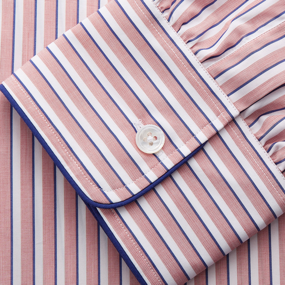 The Orange Multi Stripe Cotton Sussex Nightshirt by Turnbull & Asser features a classic collar, red and white vertical stripes, a chest pocket with blue trim, button-down front, and curved hem—a luxe take on the traditional nightshirt.