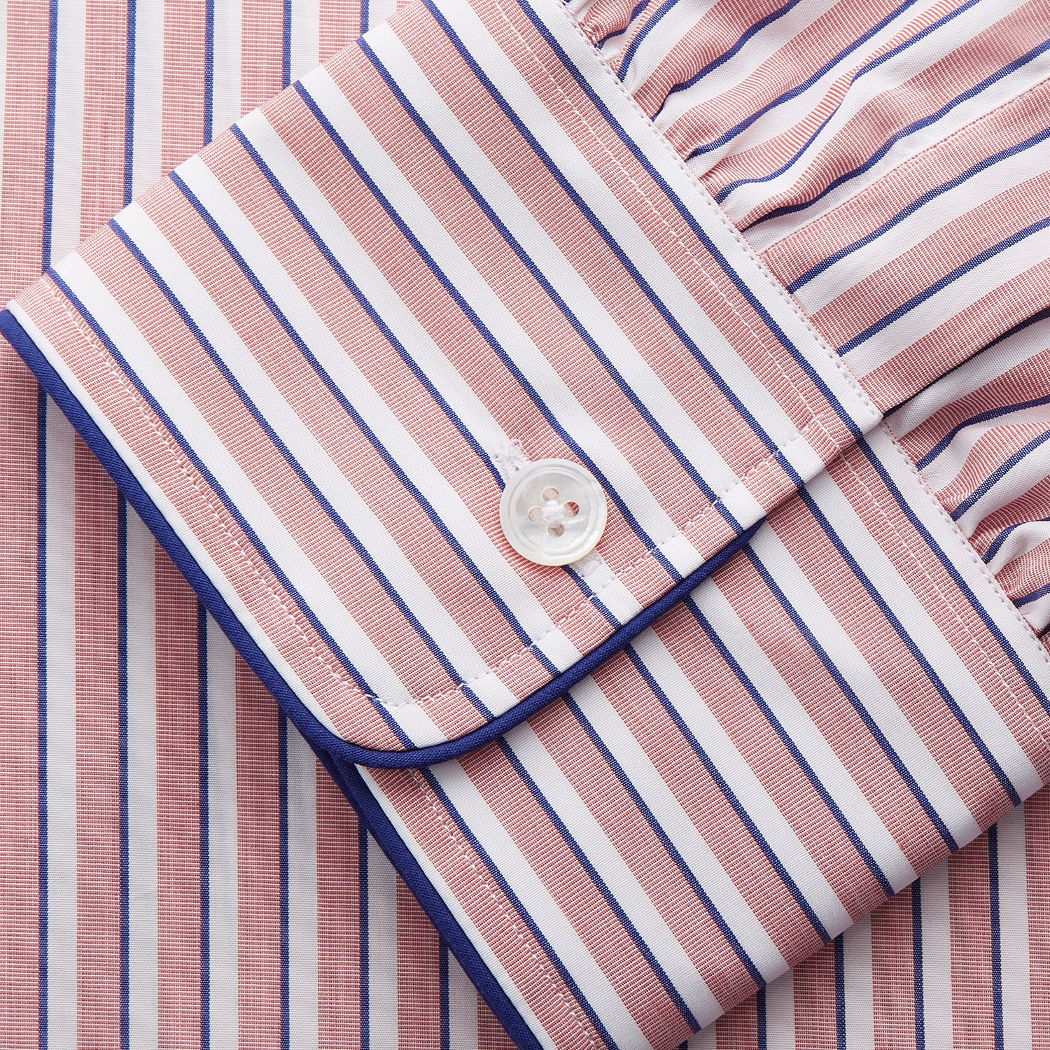 View 5 of product The Orange Multi Stripe Cotton Sussex Nightshirt by Turnbull & Asser features a classic collar, red and white vertical stripes, a chest pocket with blue trim, button-down front, and curved hem—a luxe take on the traditional nightshirt.