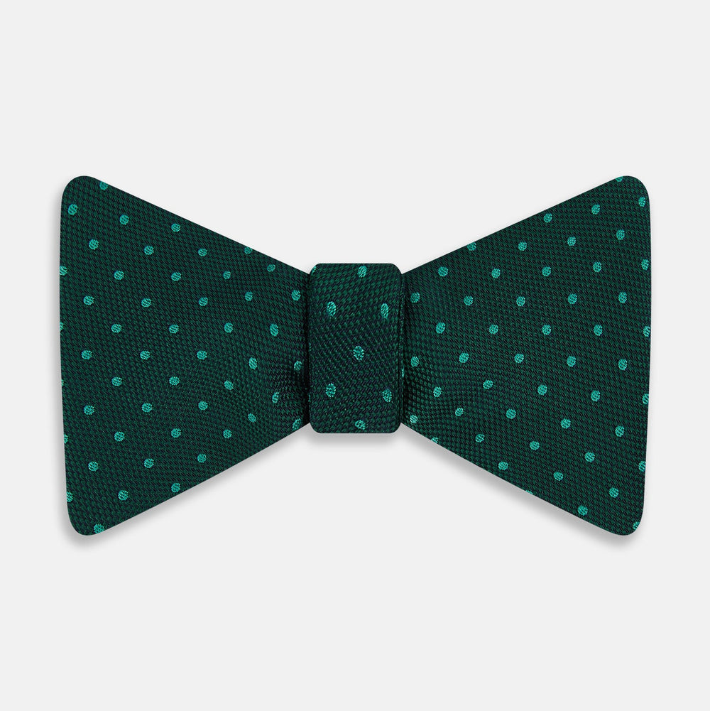 The Turnbull & Asser Dark Green and Navy Micro Dot Silk Bow Tie, featuring a refined dotted pattern, is showcased on a plain white background—an elegant accessory perfect for any occasion.