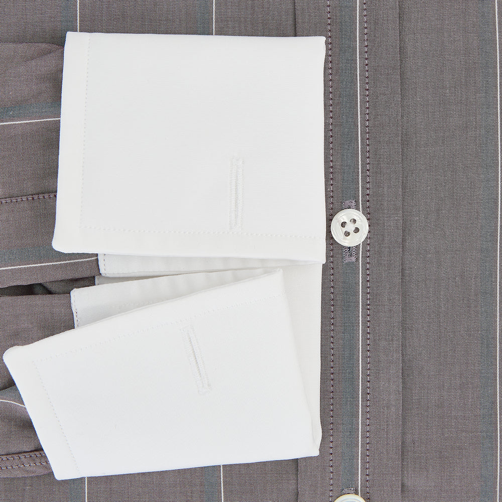 The Turnbull & Asser Light Porto Red Track Stripe Shirt features a Mayfair fit and contrast white T&A collar and cuffs, with vertical blue stripes on mauve, exemplifying British craftsmanship.