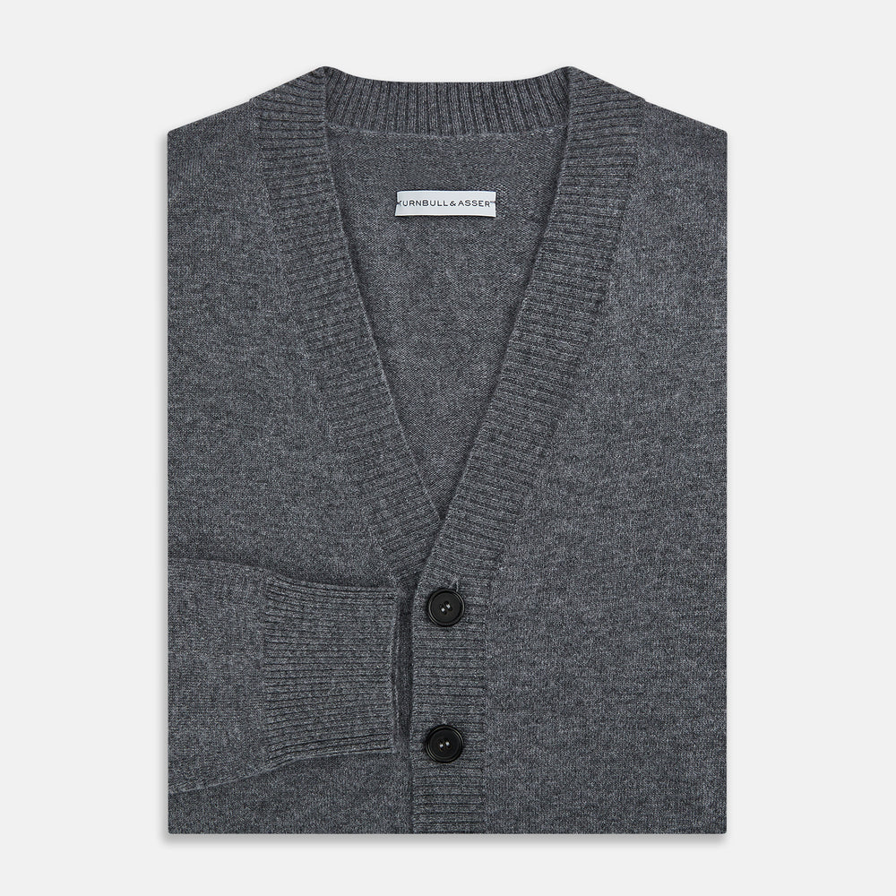 The Turnbull & Asser Grey Melange Cashmere Cardigan features a V-neck, ribbed cuffs and hem, front buttons, and two pockets—an elegant piece from our timeless knitwear collection. Shown here against a plain white background.
