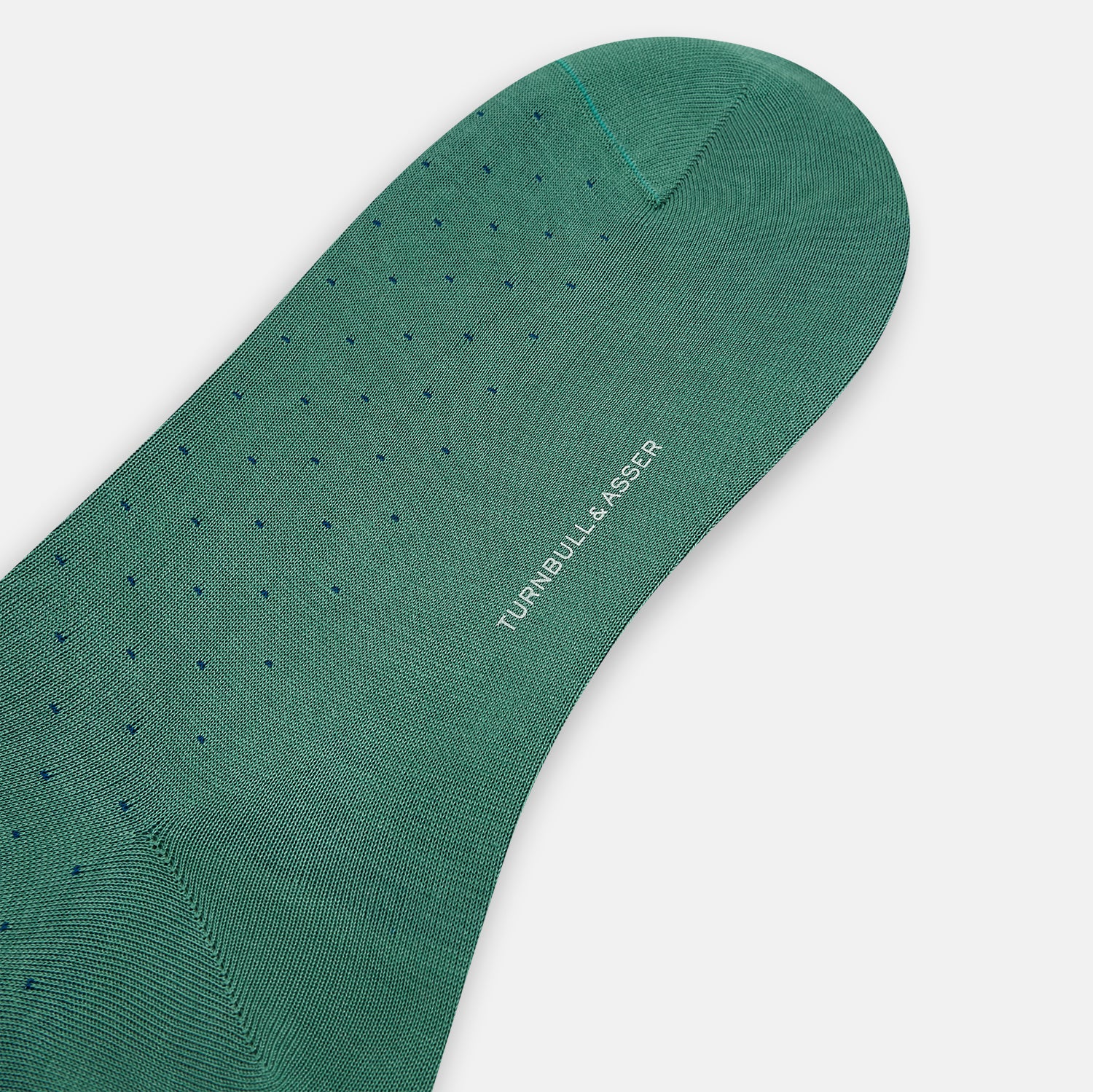 View 3 of product The Turnbull & Asser Forest Green/Navy Dot Mid-Length Sock is shown upright with the foot pointed right against a white background, highlighting its subtle polka dot pattern.