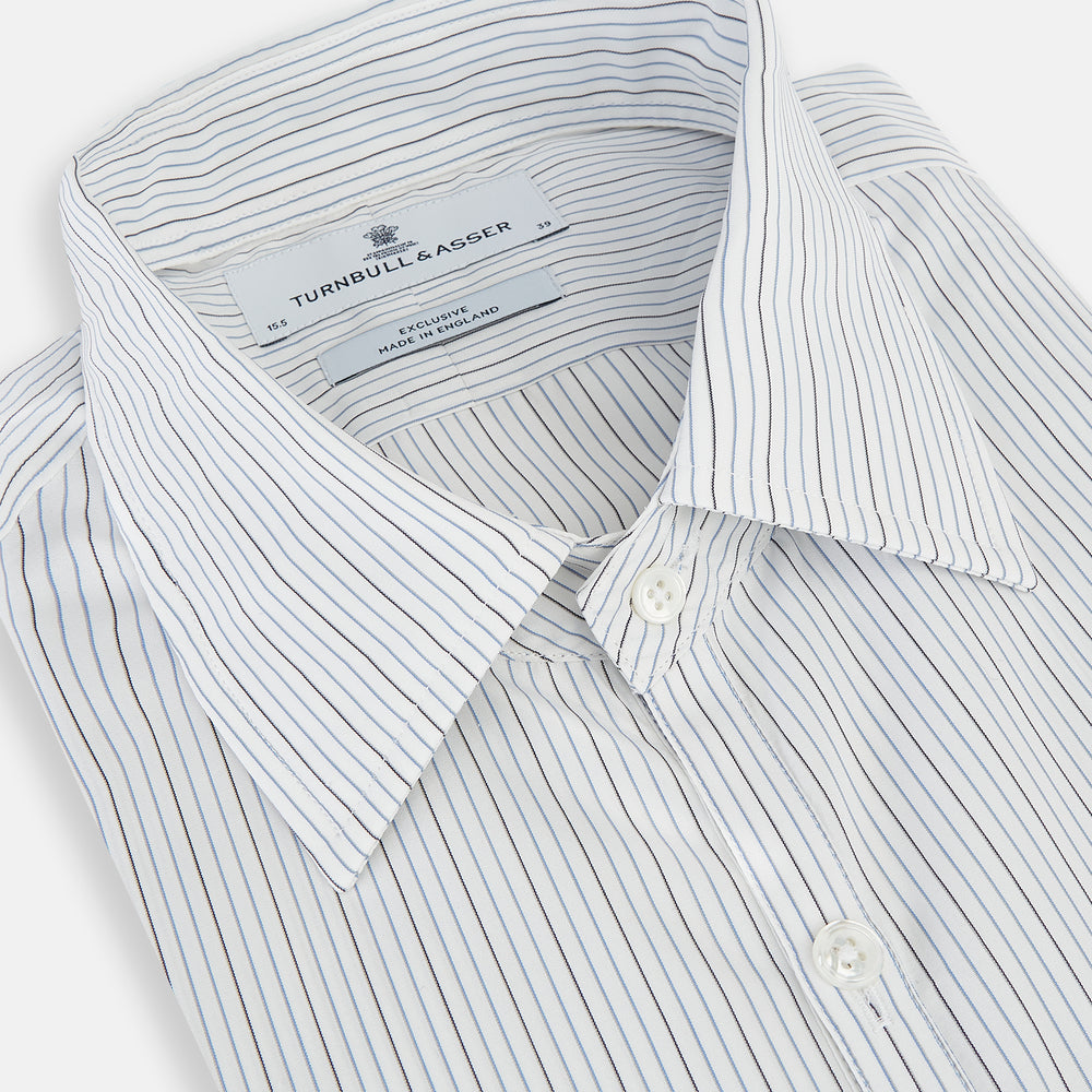 The Turnbull & Asser Grey and Blue Pinstripe Westminster Shirt features fine stripes, a classic collar, and buttoned cuffs—showcasing signature British craftsmanship against a plain white backdrop.