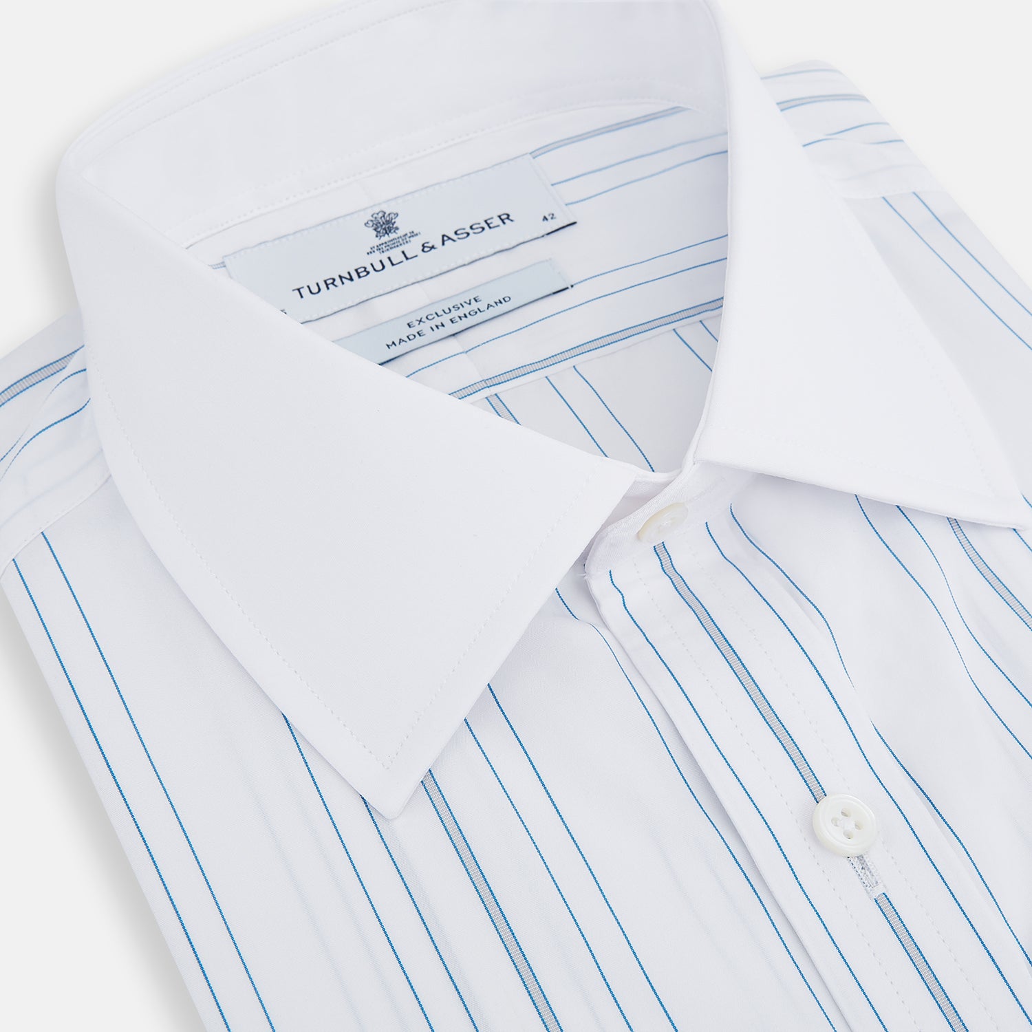 View 2 of product The Turnbull & Asser Pale Blue Multi Stripe Shirt features thin vertical stripes, a contrast collar, and double cuffs, displayed on a plain light background.