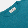 View 2 of product The Teal Glenn Crew Neck Jumper by Turnbull & Asser is shown against a white background, featuring a classic long-sleeve design with ribbed cuffs, collar, and hem.