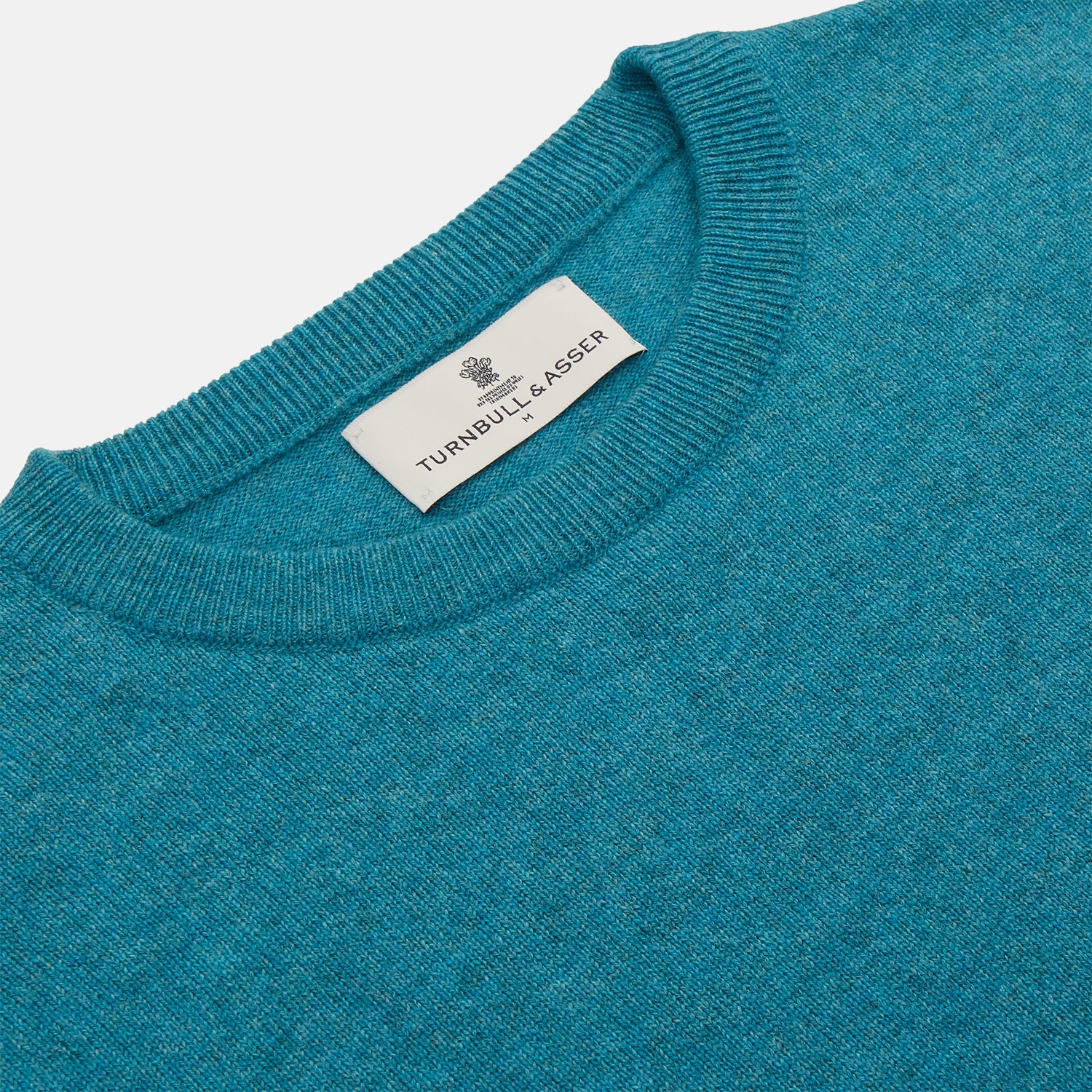 View 2 of product The Teal Glenn Crew Neck Jumper by Turnbull & Asser is shown against a white background, featuring a classic long-sleeve design with ribbed cuffs, collar, and hem.