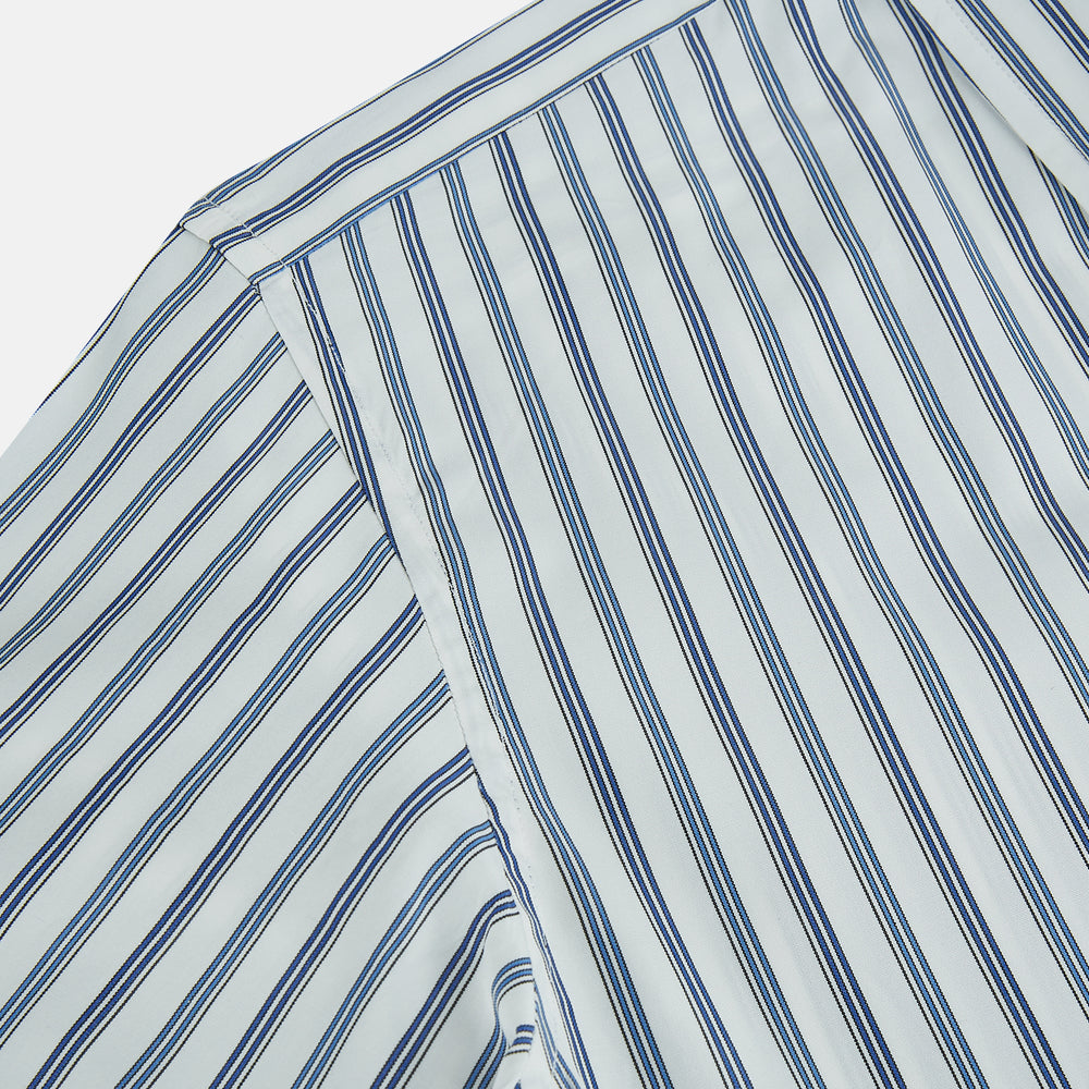 The SAPPHIRE BLUE MULTI TRACK STRIPE WINDSOR SHIRT by Turnbull & Asser features long sleeves, button-up front, classic collar, blue and white vertical stripes, buttoned cuffs, and showcases British craftsmanship on a white background.