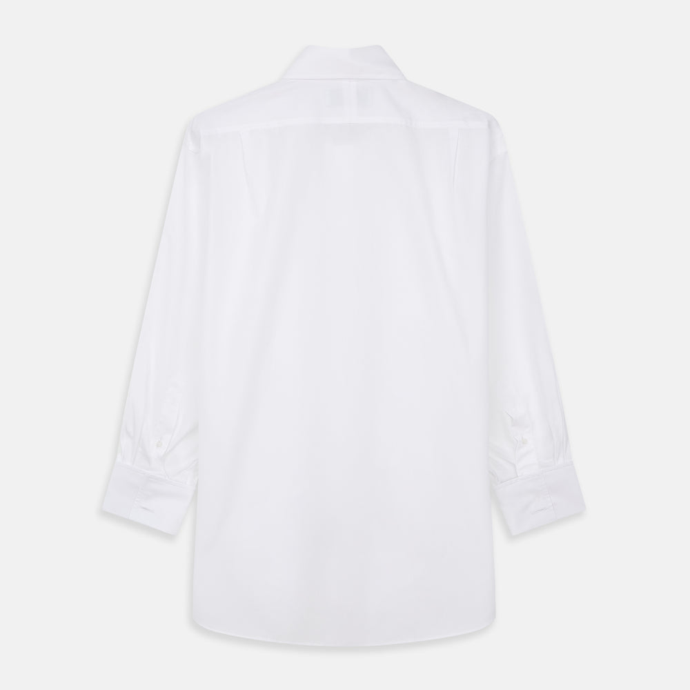 A woman with straight brown hair pulled back wears the Turnbull & Asser White Cotton Marlene Shirt, featuring classic menswear details, paired with high-waisted cream trousers against a neutral background.