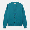 View 1 of product The Teal Lachlan Cashmere Cardigan by Turnbull & Asser features long sleeves, front pockets, and ribbed hem and cuffs. Displayed flat on a white background, this cozy piece is inspired by classic Scottish knitwear.