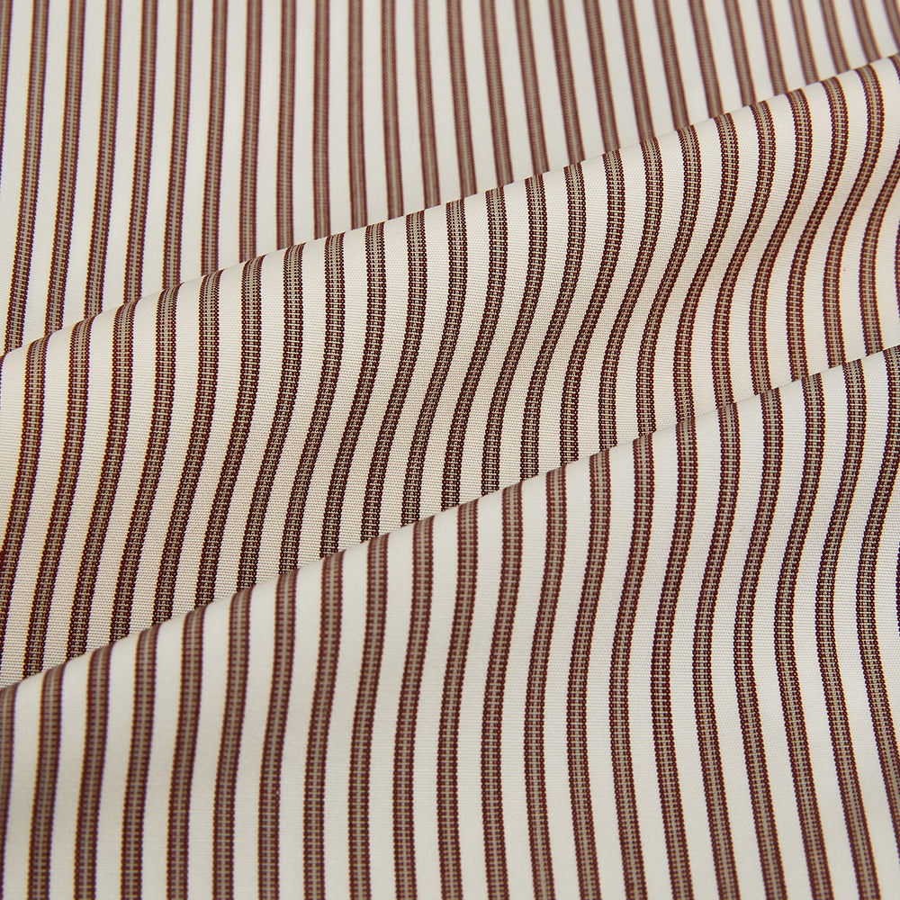 The Burgundy Halo Stripe Westminster Shirt by Turnbull & Asser features long sleeves, a button-up front, a Westminster collar, and thin vertical brown and white stripes, shown on a plain white background.