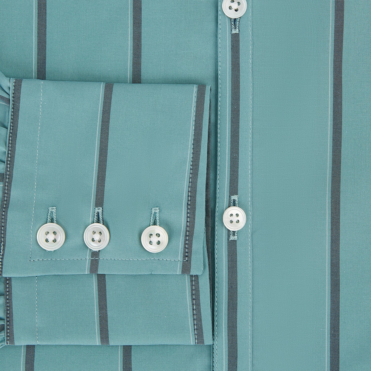 View 4 of product The Turnbull & Asser Sage Track Stripe Westminster Shirt features long sleeves, a tailored fit, a collar, and vertical dark blue stripes, with button closures down the front and at the cuffs, shown laid flat on a white background.