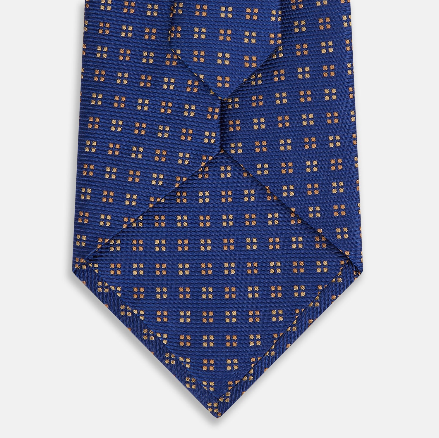 View 3 of product The Turnbull & Asser Bronze and Blue Multi Dot Silk Tie features a refined blue background with multicolored dots, elegantly displayed on a plain white backdrop—an ideal choice for a modern office look.