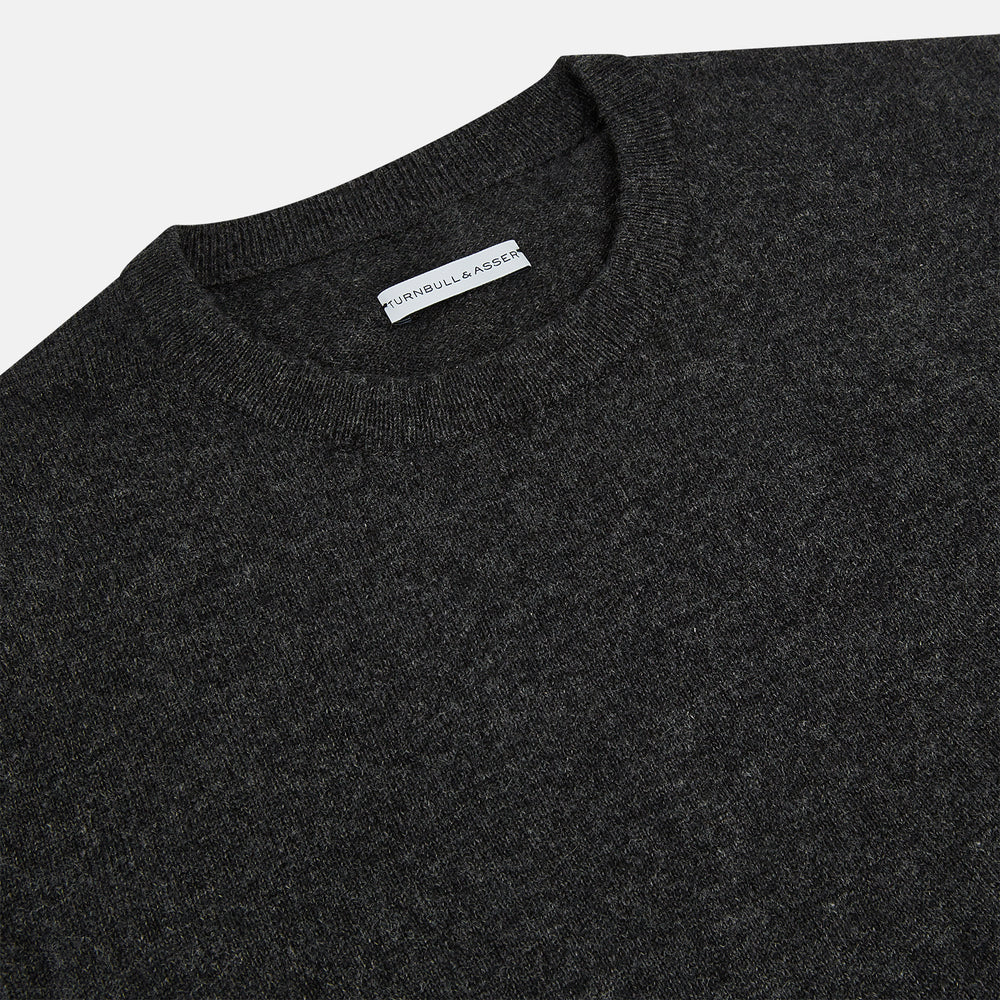 The Turnbull & Asser Dark Grey Cashmere Round Neck Jumper features a classic, plain long-sleeve design and is displayed on a white background.