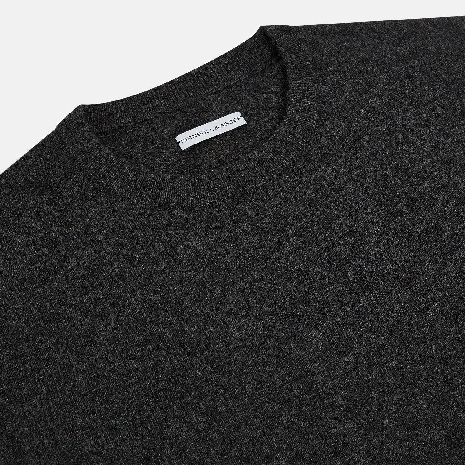 View 2 of product The Turnbull & Asser Dark Grey Cashmere Round Neck Jumper features a classic, plain long-sleeve design and is displayed on a white background.