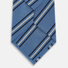 View 3 of product The Blue Multi Stripe Silk Blend Tie by Turnbull & Asser features diagonal navy and light beige stripes, shown rolled up on a white background—a timeless formal accessory.
