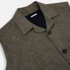 View 2 of product The Turnbull & Asser Olive Collared Linen Waistcoat is a sleeveless olive waistcoat with a collar, front buttons, one chest pocket, and two zippered side pockets, shown against a plain white background.