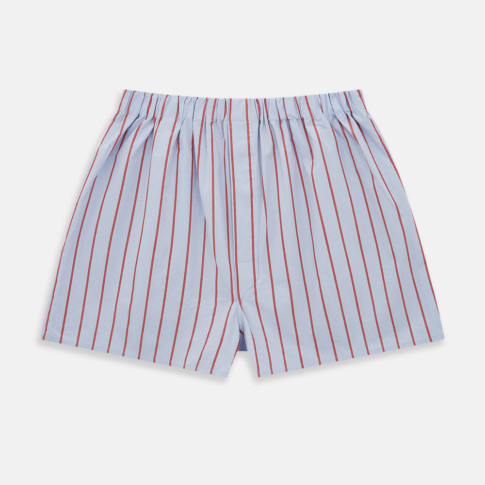 The Turnbull & Asser Pale Blue And Red Pinstripe Godfrey Boxer Shorts feature an elastic waistband and loose fit, made from Italian cotton, shown on a plain white background.