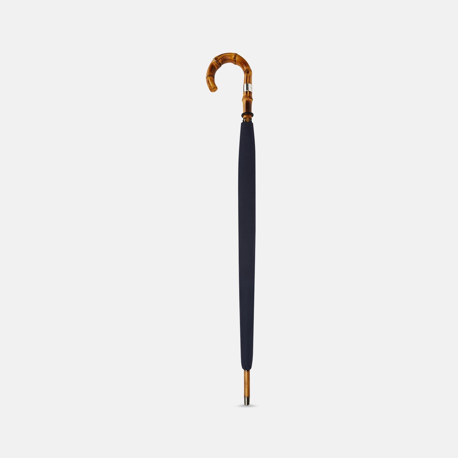 View 2 of product The Turnbull & Asser Navy Umbrella with Whangee Crook Handle is fully open, displaying its dark blue canopy and wooden curved handle against a plain white background.