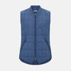 View 1 of product The Azzurro Quilted Gilet by Turnbull & Asser is a sleeveless, lightweight men’s outerwear piece featuring a front zipper, angled zippered pockets, and a chest pocket, shown against a plain white background.
