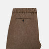 View 5 of product The Turnbull & Asser Pine Cone Linen Herringbone Miles Trousers feature a relaxed fit, elasticated waistband, and drawstring tie, shown against a plain white background.