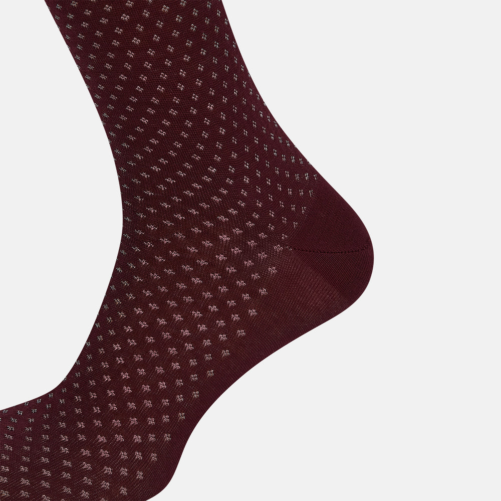 The Turnbull & Asser Burgundy Motif Mid-Length Socks, crafted from mercerised Egyptian cotton and featuring small white polka dots, are shown side by side on a plain white background.