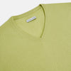View 2 of product The Turnbull & Asser Melon Green Cashmere V-Neck Jumper features long sleeves with ribbed cuffs and hem, shown against a plain white background.