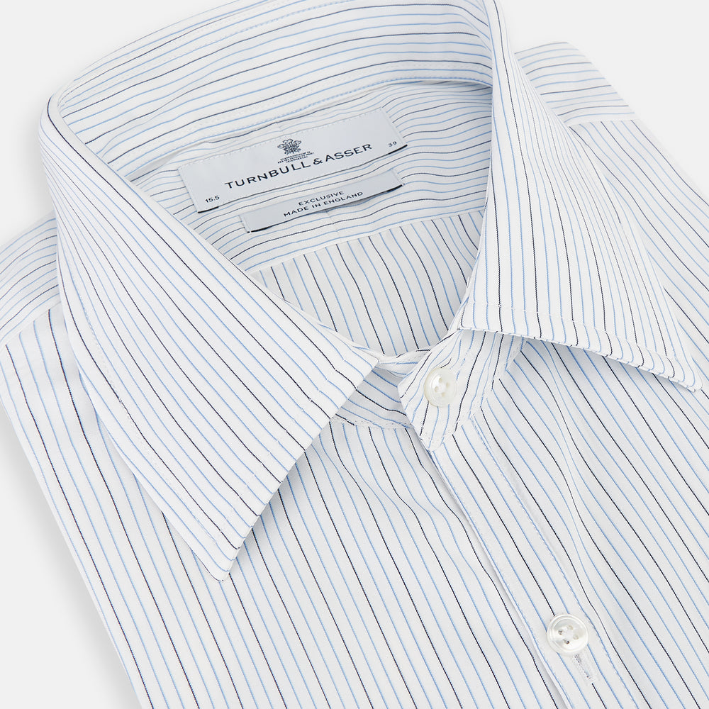 The Turnbull & Asser Pale Blue and Navy Pinstripe Westminster Shirt features long sleeves, a classic collar, and buttoned cuffs, highlighting British craftsmanship. The shirt is laid flat on a white background.