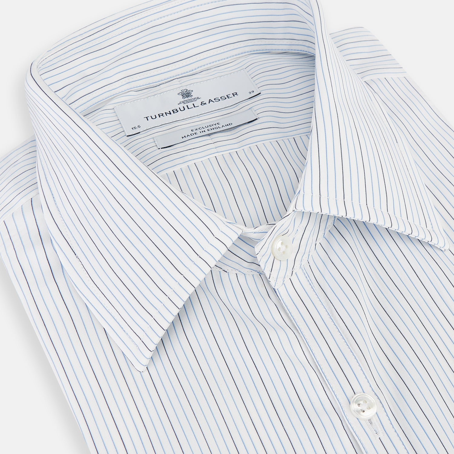 View 2 of product The Turnbull & Asser Pale Blue and Navy Pinstripe Westminster Shirt features long sleeves, a classic collar, and buttoned cuffs, highlighting British craftsmanship. The shirt is laid flat on a white background.