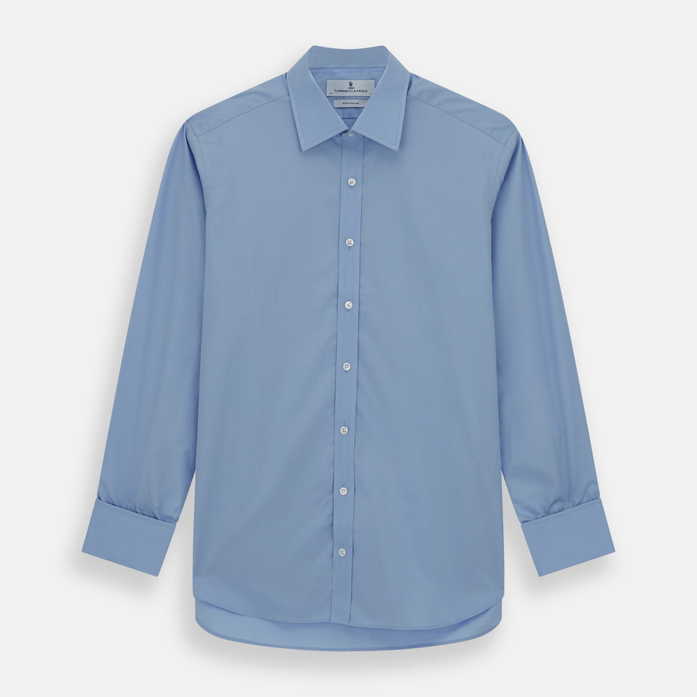 The Turnbull & Asser Blue Cotton Shirt features a T&A collar, double cuffs, and white buttons. This classic formal shirt is perfect for any gentleman and pairs effortlessly with a navy suit. Displayed on a plain white background.