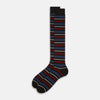 View 2 of product The Turnbull & Asser Dark Chocolate Striped Merino Wool Long Socks are knee-high, featuring horizontal black, red, blue, and gray stripes on a white background.