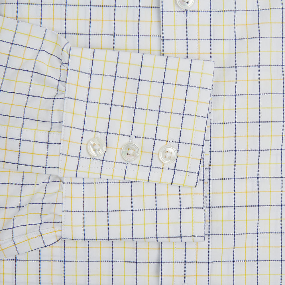 The Turnbull & Asser Yellow Overlay Grid Check Mayfair Shirt is a long-sleeve, button-down shirt made from soft organic cotton, featuring a yellow grid check pattern and shown laid flat on a white background.