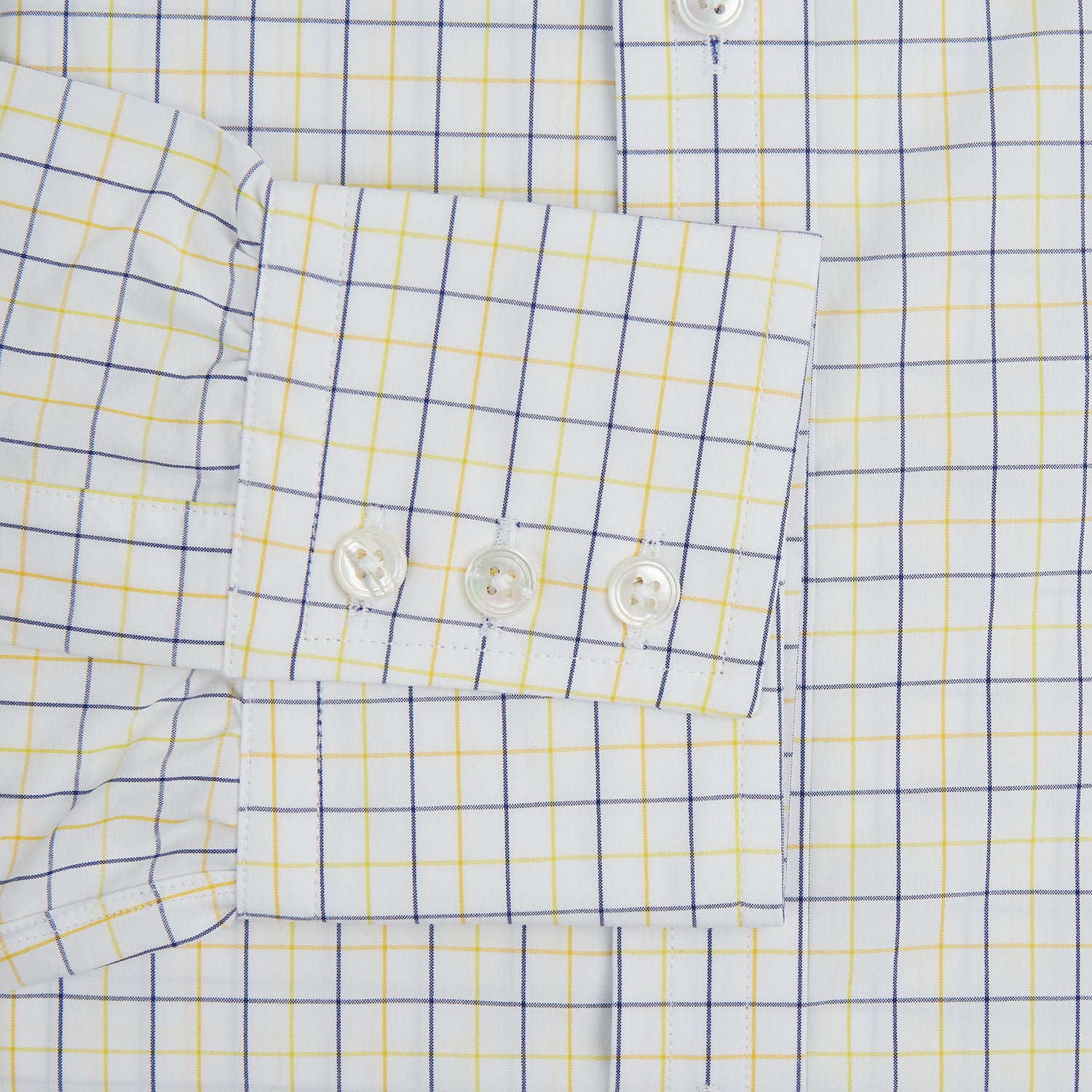 View 4 of product The Turnbull & Asser Yellow Overlay Grid Check Mayfair Shirt is a long-sleeve, button-down shirt made from soft organic cotton, featuring a yellow grid check pattern and shown laid flat on a white background.