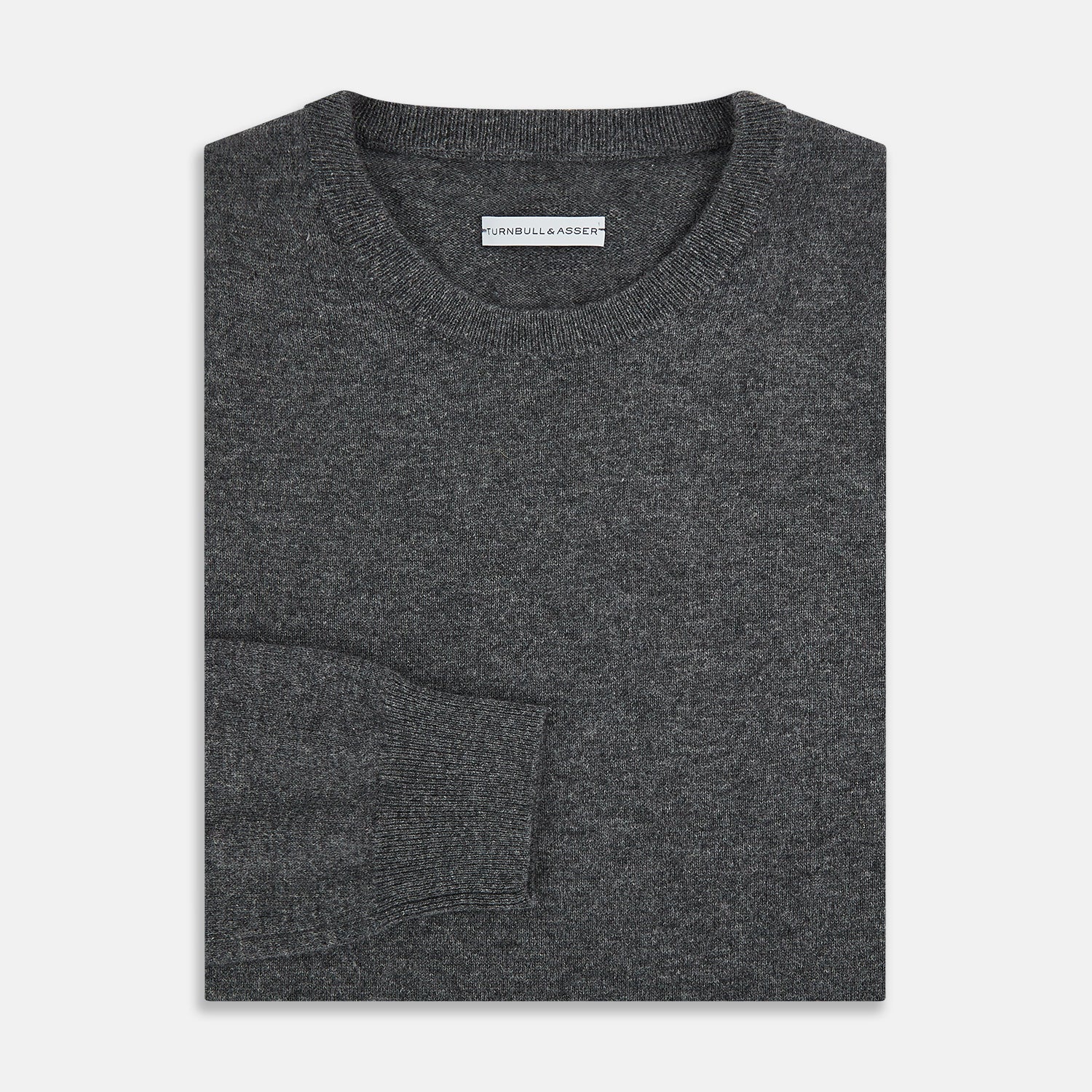 View 4 of product The Turnbull & Asser Charcoal Grey Cashmere Round Neck Jumper features a crew neck, long sleeves, and ribbed cuffs, collar, and hem—an essential piece of men’s knitwear displayed on a white background.
