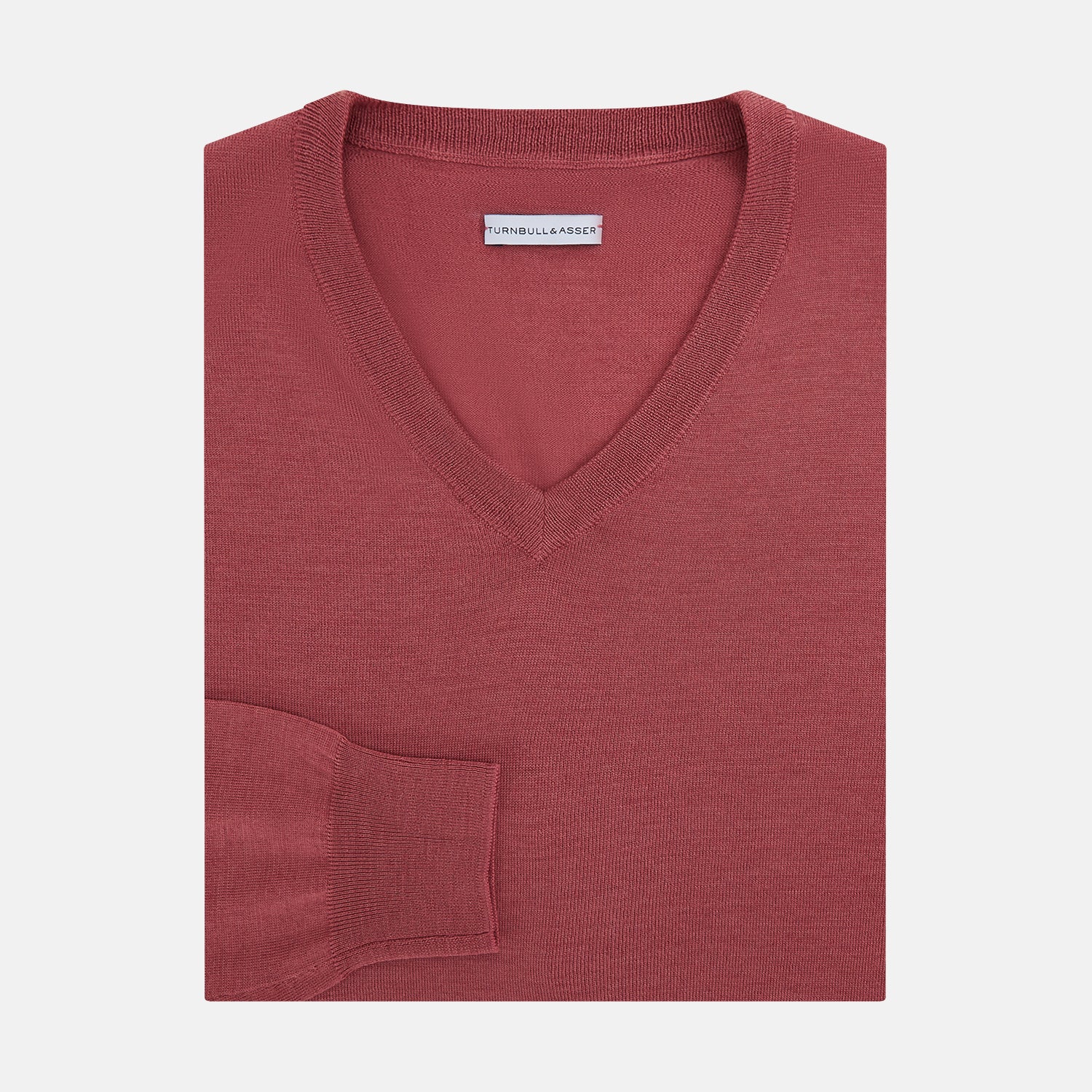 View 4 of product The Turnbull & Asser Antique Pink Merino V-Neck Jumper features ribbed cuffs, hem, and neckline in a soft antique pink, shown on a plain white background. Part of our knitwear collection.