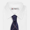 View 2 of product The Turnbull & Asser FONDANT PINK and WINDOW PANE NAVY Silk Tie features a subtle ribbed texture with a pink grid pattern on navy—an elegant choice for polished office attire, shown neatly rolled on a white background.