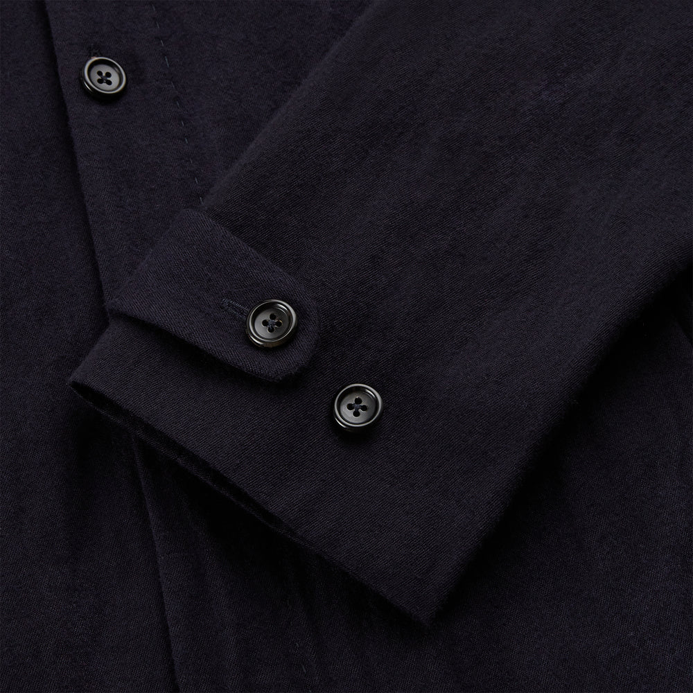 A navy button-up Primrose overshirt by Turnbull & Asser with a classic collar, two side pockets, a left chest pocket, and buttoned cuffs—an ideal blazer alternative, shown on a plain white background.