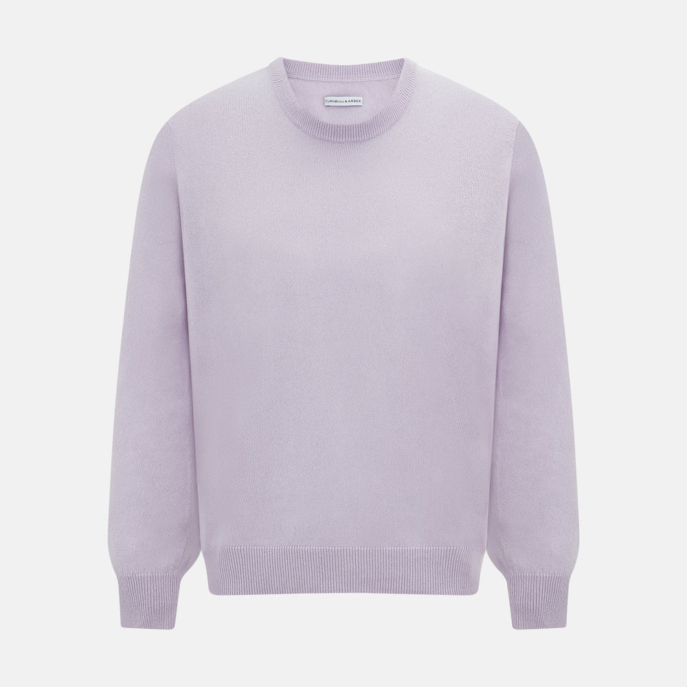 The Turnbull & Asser Lilac Cashmere Round Neck Jumper for men features long sleeves with ribbed cuffs and hem, offering a stylish, refined look. Shown against a white background.