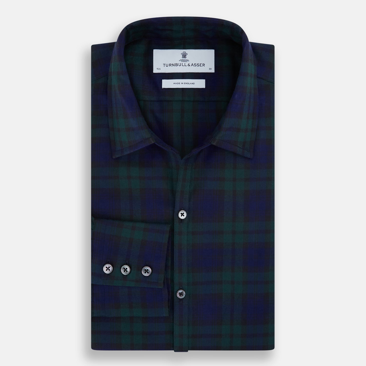 View 5 of product The Turnbull & Asser Black Watch Tartan Windsor Shirt is a long-sleeve, button-up shirt with a dark green and navy tartan pattern, white buttons, collar, and curved hem—showcasing British craftsmanship on a plain white background.