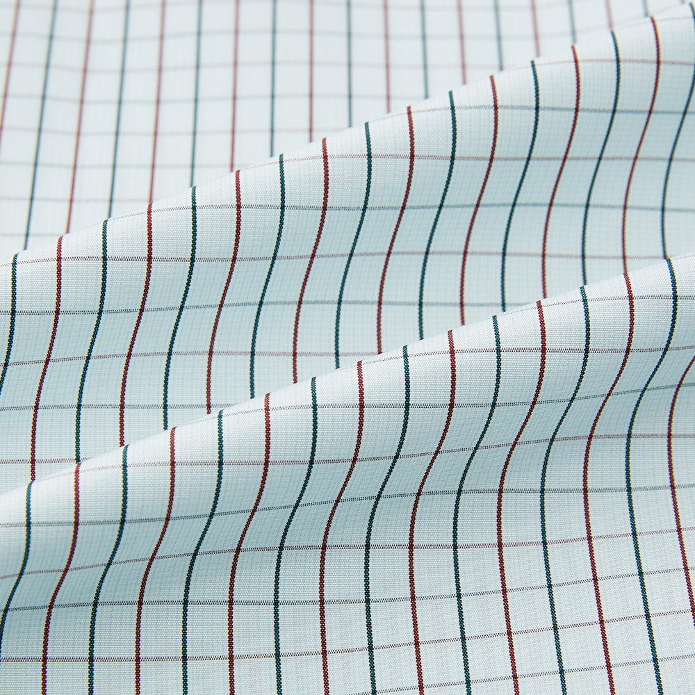 The Turnbull & Asser Forest Melange and Red Overlay Grid Check Westminster Shirt features long sleeves, a pointed collar, and buttoned cuffs, highlighting British craftsmanship. It's shown laid flat against a white background.