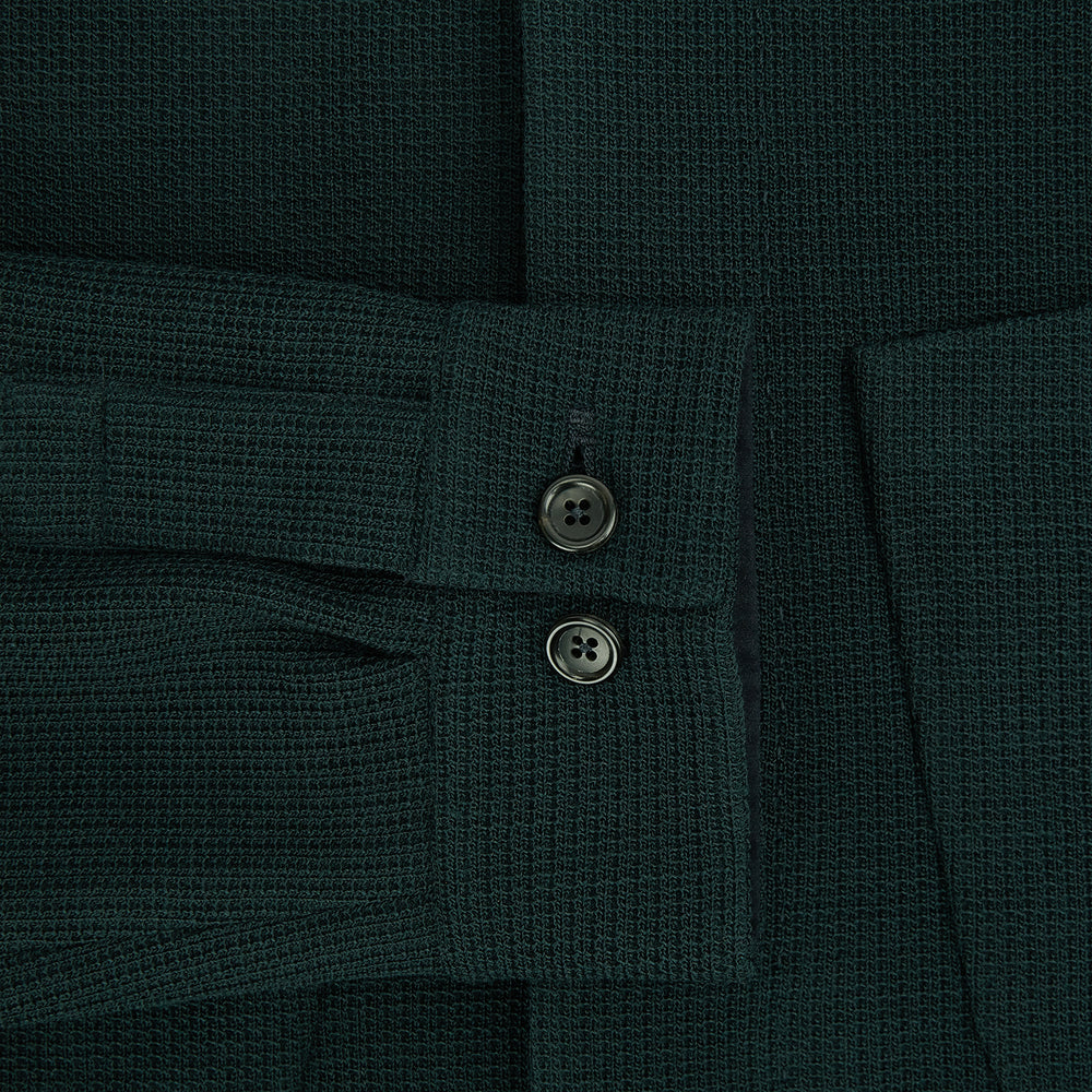The Forest Green Greenwich Knitted Overshirt by Turnbull & Asser, crafted from Italian wool, features long sleeves, a collar, front buttons, and two chest pockets—one flap, one open—shown on a white background.