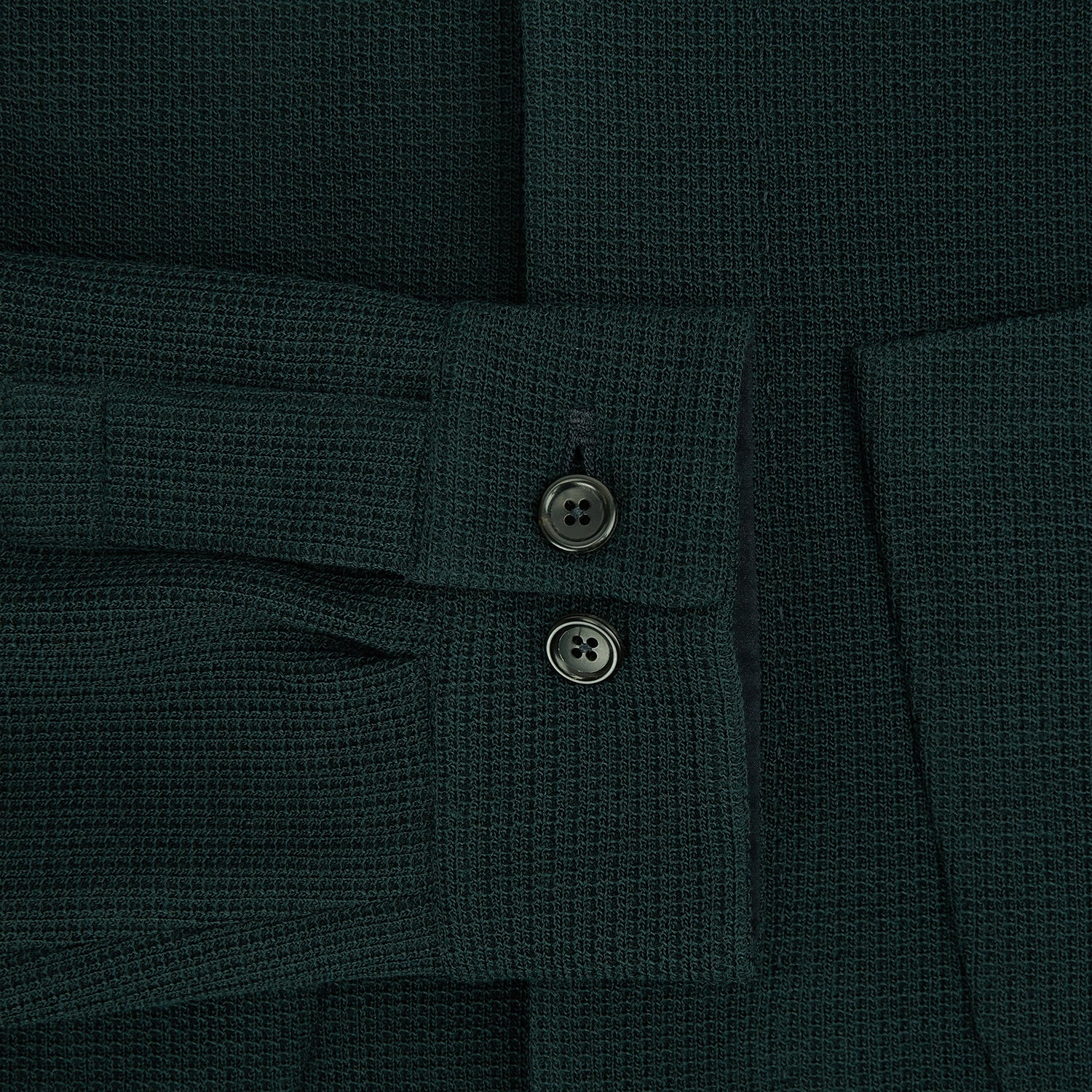 View 4 of product The Forest Green Greenwich Knitted Overshirt by Turnbull & Asser, crafted from Italian wool, features long sleeves, a collar, front buttons, and two chest pockets—one flap, one open—shown on a white background.