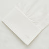 View 4 of product The Turnbull & Asser Cream Silk Weekend Fit Fairlight Shirt is a classic, soft-touch long-sleeve shirt with a collar, button-down front, and buttoned cuffs, shown laid flat on a plain white background.