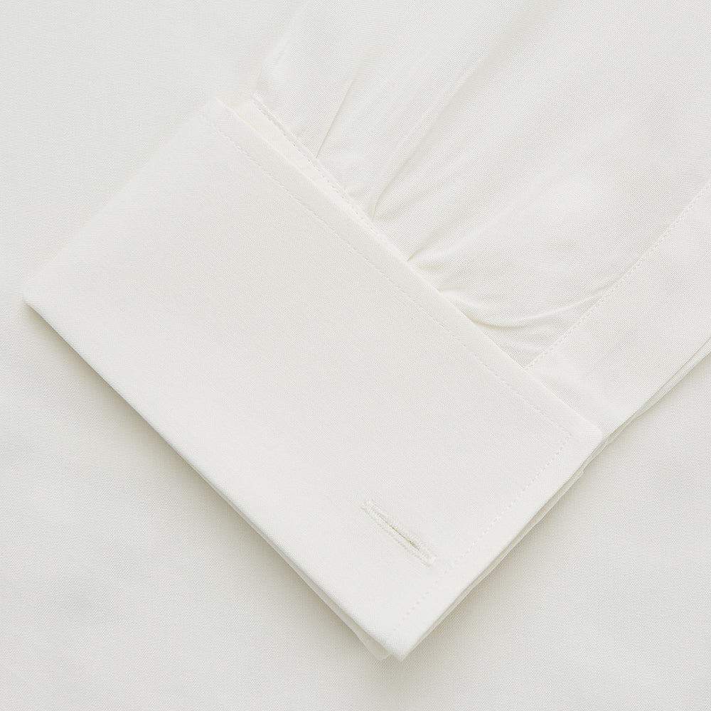 The Turnbull & Asser Cream Silk Weekend Fit Fairlight Shirt is a classic, soft-touch long-sleeve shirt with a collar, button-down front, and buttoned cuffs, shown laid flat on a plain white background.