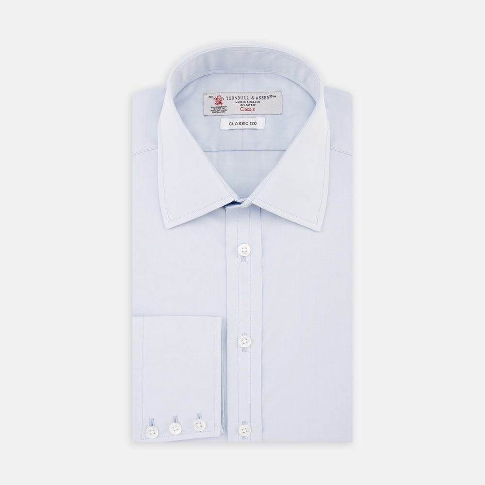 A plain, light blue circle with a thick blue border and a thin white inner border, centered on a white background, representing Turnbull & Asser’s Light Blue 120-Cotton Poplin Fabric.