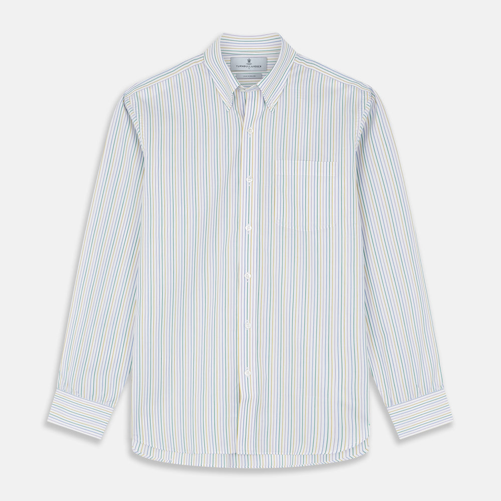 A man wears the Turnbull & Asser Yellow Multi Blazer Stripe Weekend Fit Suffolk Shirt, standing against a beige background with his hands relaxed—a casual look perfect for weekends.