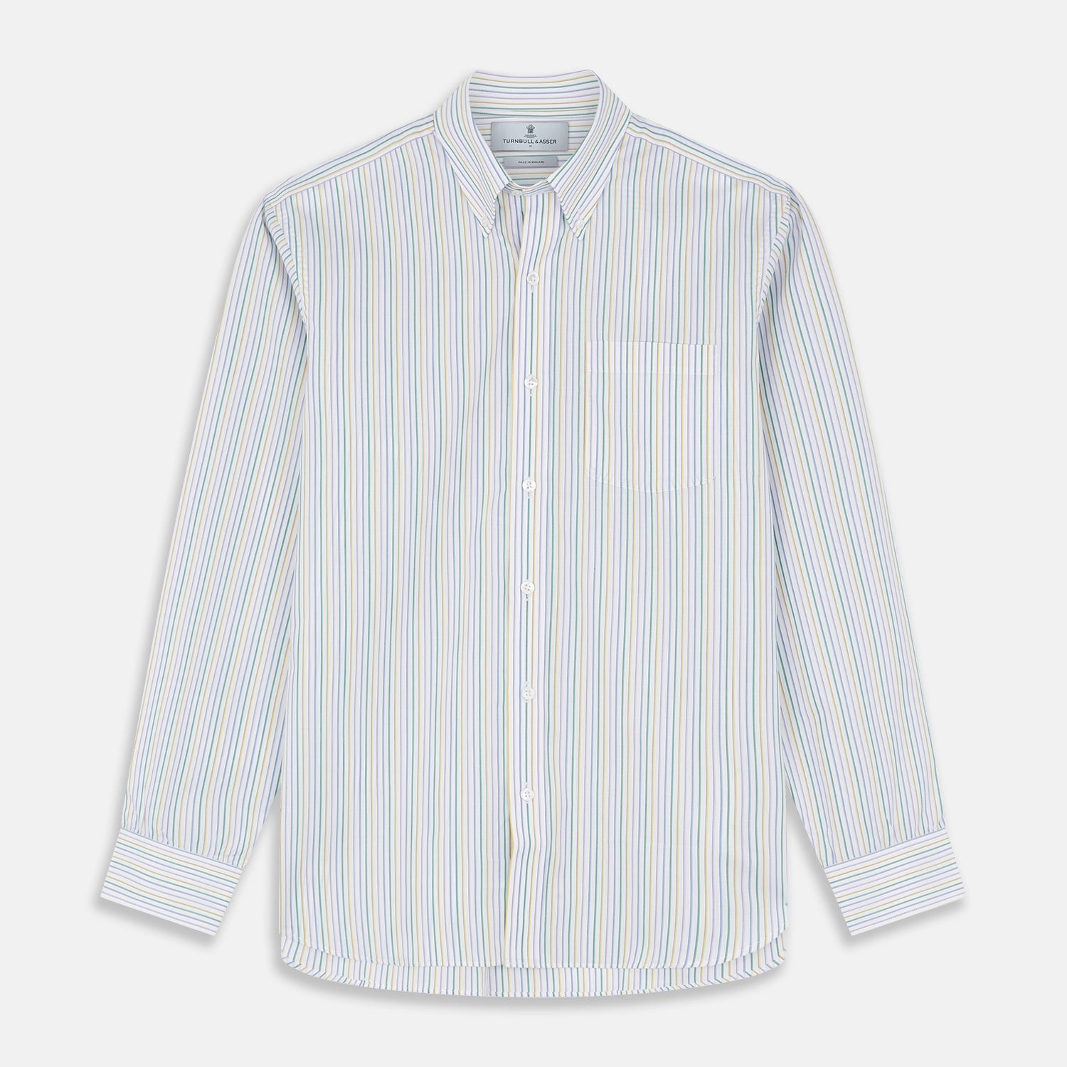 View 2 of product A man wears the Turnbull & Asser Yellow Multi Blazer Stripe Weekend Fit Suffolk Shirt, standing against a beige background with his hands relaxed—a casual look perfect for weekends.